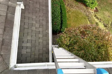 A ladder going up to the top of stairs.